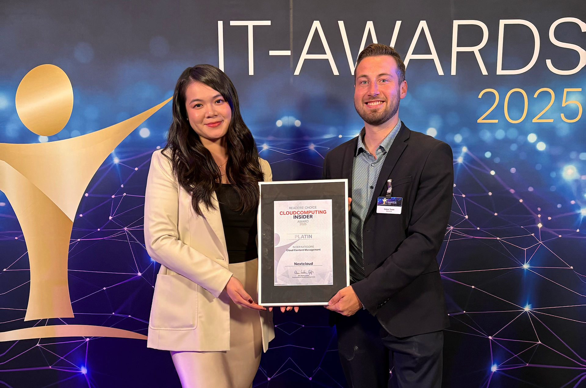 Picture of the Cloud Computing Insider IT Awards 2025 showing two people from holding the Cloud Content Management Platinum winner certificate for Nextcloud.
