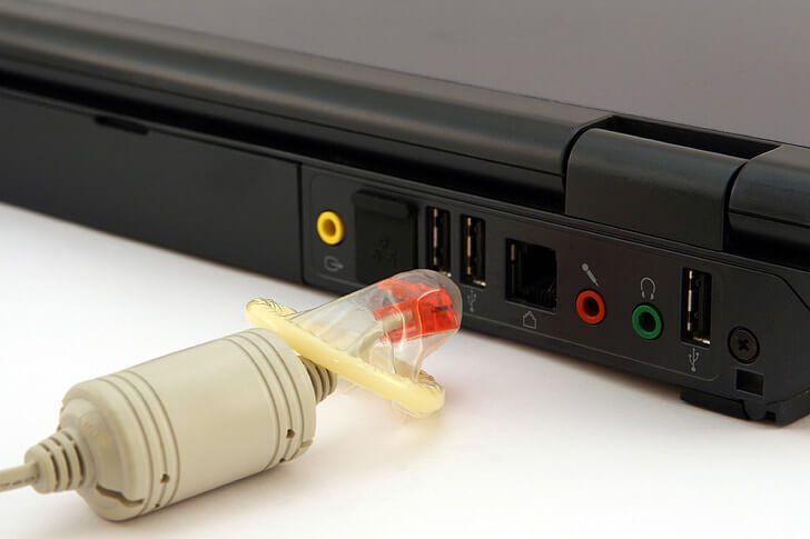 network cable with condom around it and laptop